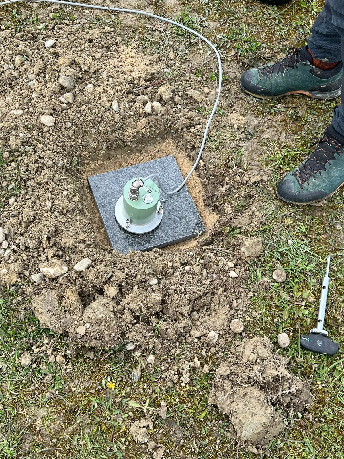 A seismic instrument installed in the ground.